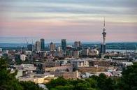 Twilight skyline of Auckland featuring the Sky Tower under a colorful evening sky